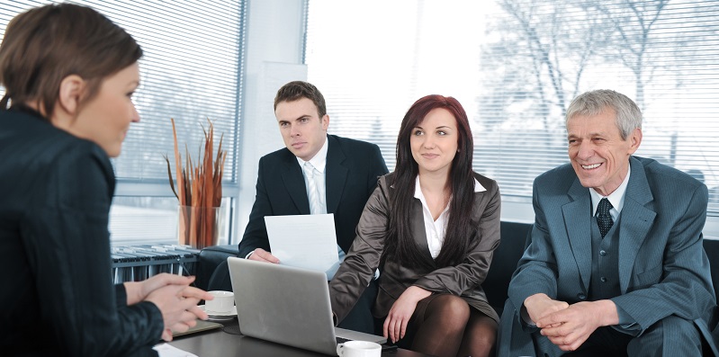 Businesswoman in an interview with three business people getting positive feedback