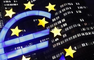 An illuminated euro sign is seen in front of the headquarters of the European Central Bank in Frankfurt