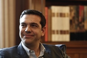 Tsipras, leader of Greece's far-left Syriza party smiles during a meeting with Greek President Papoulias at the Presidential palace in Athens