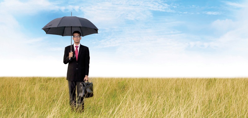 Businessman with umbrella shot outdoor