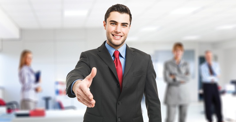 Portrait of an handsome businessman giving an handshake