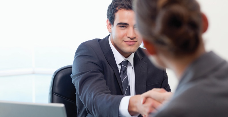 Manager interviewing a female applicant in his office