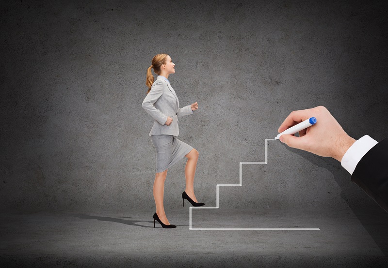 business and education concept - smiling businesswoman stepping up staircase