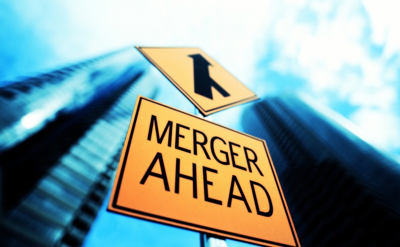 MERGER SIGN BELOW OFFICE BUILDING