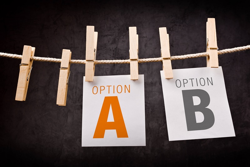 Concept of choice between two options marked as A and B. Letters are printed on note paper and attached to crope with clothes pins.