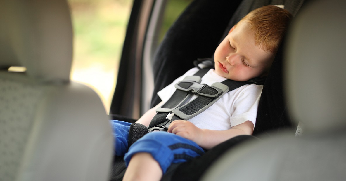 Boy sleeping in child car seat. Shallow DOF.