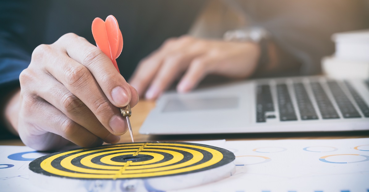 Businessman holding red dart push on target. Business strategy planning success target goals. Business development concept