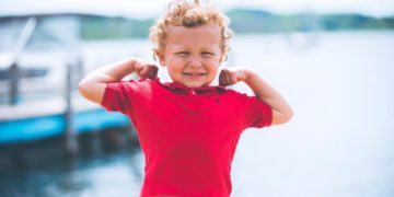boy standing near dock