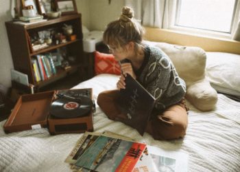 woman sitting on bed