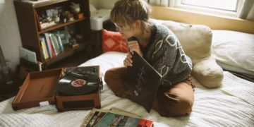 woman sitting on bed