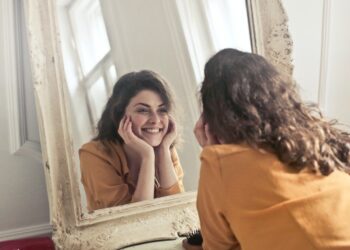 photo-of-woman-looking-at-the-mirror-insurancedaily