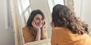 photo-of-woman-looking-at-the-mirror-insurancedaily