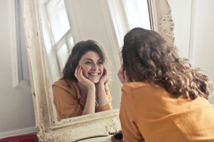 photo-of-woman-looking-at-the-mirror-insurancedaily