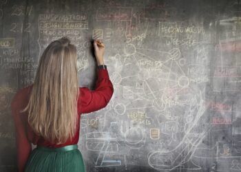 woman-in-red-long-sleeve-writing-on-chalk-board-insurancedaily