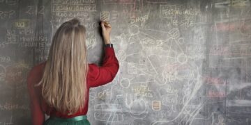 woman-in-red-long-sleeve-writing-on-chalk-board-insurancedaily