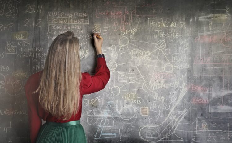 woman-in-red-long-sleeve-writing-on-chalk-board-insurancedaily
