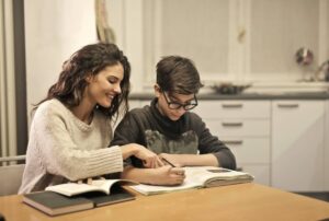 elder-sister-and-brother-studying-at-home-insurancedaily