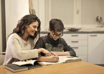 elder-sister-and-brother-studying-at-home-insurancedaily