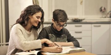 elder-sister-and-brother-studying-at-home-insurancedaily
