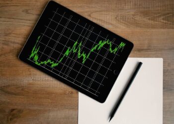 space-grey-ipad-air-with-graph-on-brown-wooden-table-insurancedaily