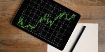 space-grey-ipad-air-with-graph-on-brown-wooden-table-insurancedaily