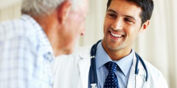 Elderly man receiving advice from male doctor