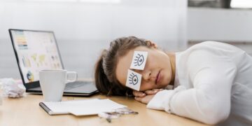tired-businesswoman-covering-her-eyes-with-drawn-eyes-paper