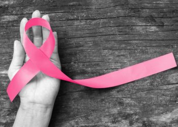 Pink ribbon for breast cancer awareness, symbolic bow color raising awareness on people living with women's breast tumor illness (bow isolated with clipping path)