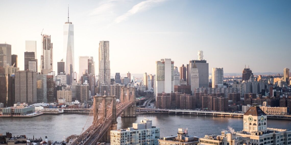 Skyline New York City Manhattan and Brooklyn Bridge At Sunset