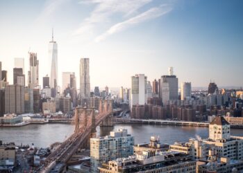 Skyline New York City Manhattan and Brooklyn Bridge At Sunset