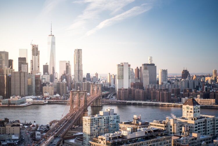 Skyline New York City Manhattan and Brooklyn Bridge At Sunset