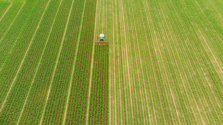 aerial-tractor-working-cultivated-fields-farmland-agriculture-occupation-top-down-view-lush-green-cereal-crops-sprintime-italy_107467-363