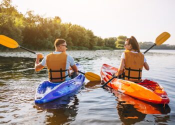 couple-together-kayaking-river