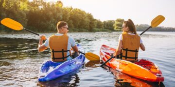 couple-together-kayaking-river