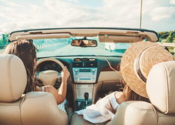 portrait-two-young-beautiful-smiling-hipster-female-convertible-car