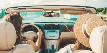 portrait-two-young-beautiful-smiling-hipster-female-convertible-car
