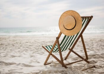 straw-hat-kept-empty-beach-chair