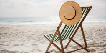 straw-hat-kept-empty-beach-chair