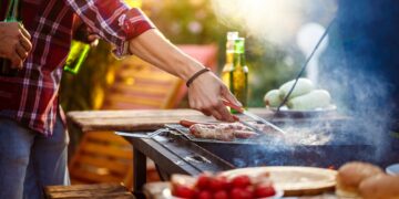 young-men-roasting-barbecue-grill-cottage-countryside