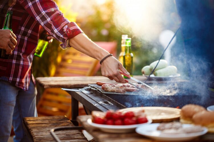 young-men-roasting-barbecue-grill-cottage-countryside