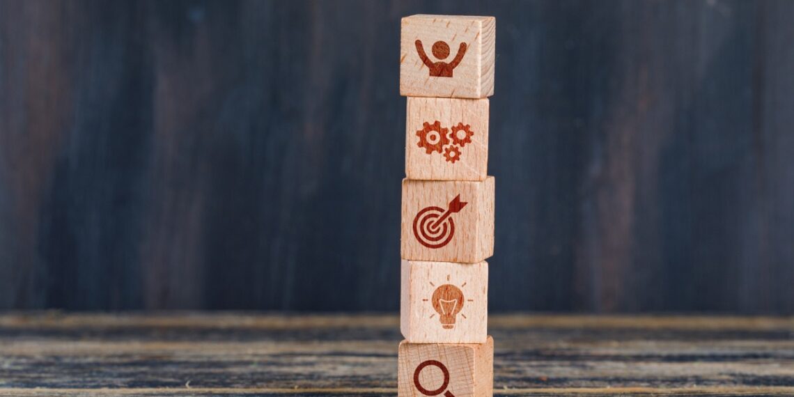 business-strategy-concept-with-wooden-cubes-wooden-grunge-background-side-view
