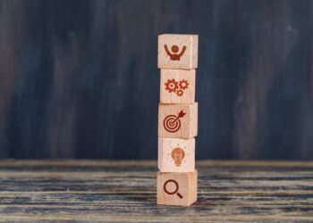 business-strategy-concept-with-wooden-cubes-wooden-grunge-background-side-view