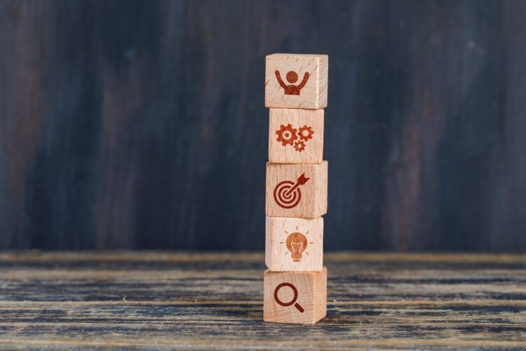 business-strategy-concept-with-wooden-cubes-wooden-grunge-background-side-view