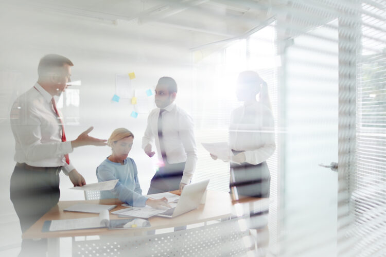 Four office workers having talk about financial rate of the company latest business project
