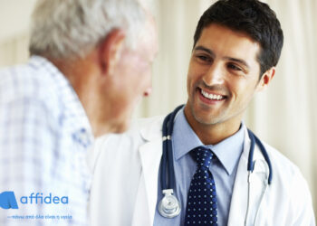 Portrait of handsome doctor talking with senior patient