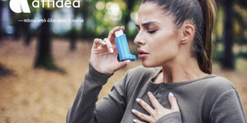 Woman using asthma inhaler